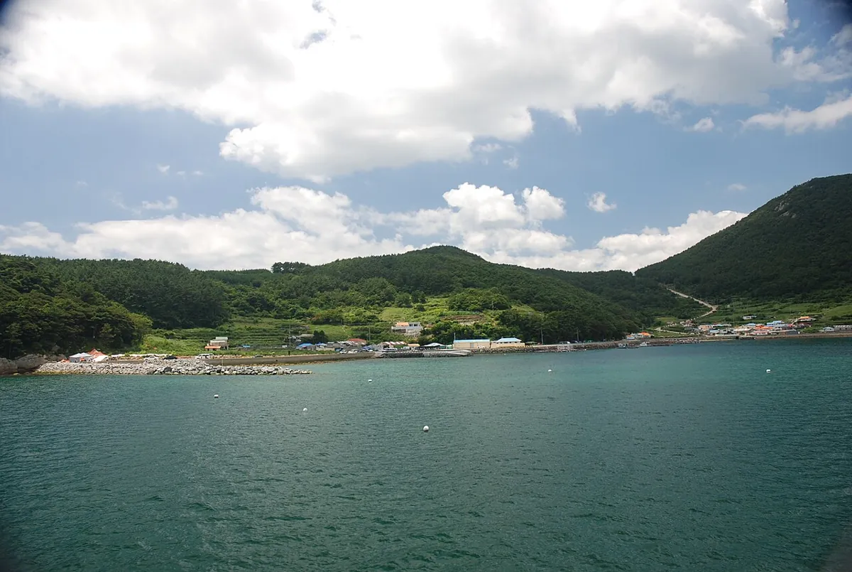 Green hills and the turquoise water of Gokryongpo Harbor on Chubongdo Island in Tongyeong.
